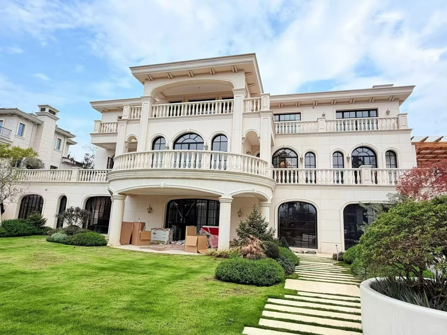 Villa facade with black-framed arched windows